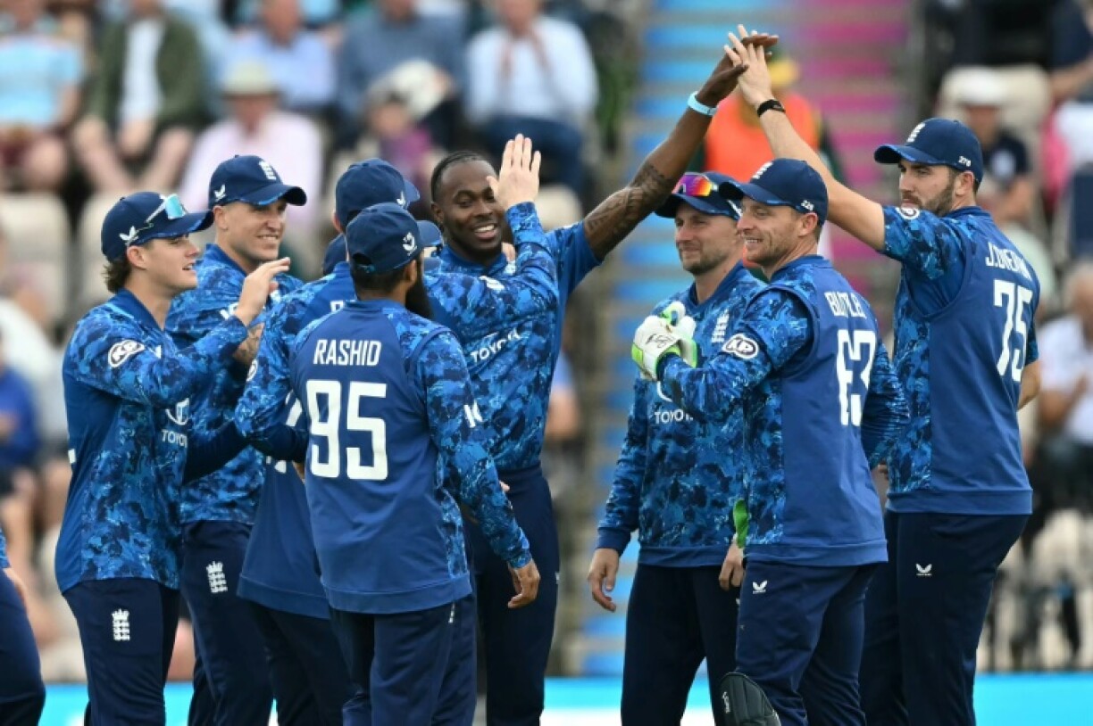 England's Jofra Archer (C) celebrates after taking a wicket against South Africa