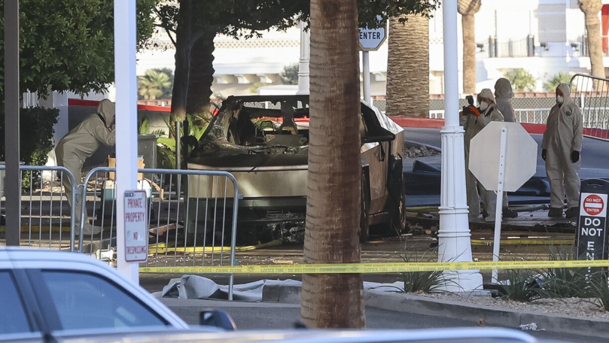 Investigators photograph a Tesla Cybertruck that exploded outside the lobby of President-elect Donald Trump's hotel in Las Vegas on 1 January 2025.