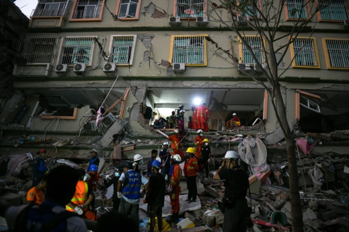 Rescue teams work to save residents trapped under the rubble of a condominium development in Mandalay on March 30, 2025
