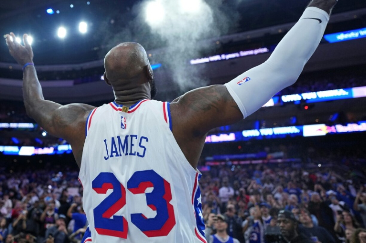 New challenge: LeBron James's trademark pre-game chalk toss now comes in a Philadelphia 76ers jersey