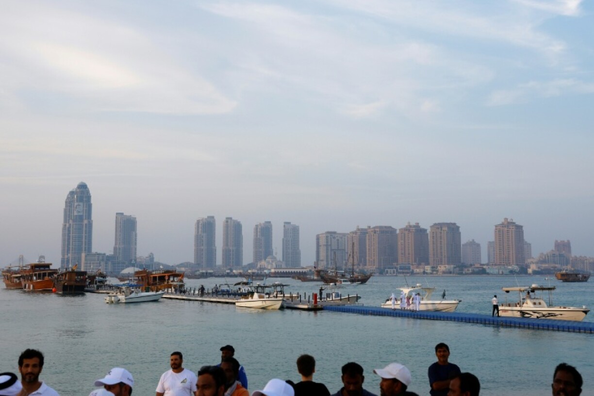 The high-rises of modern Doha dominate the skyline behind the fishing boat jetty where the festival is held.
