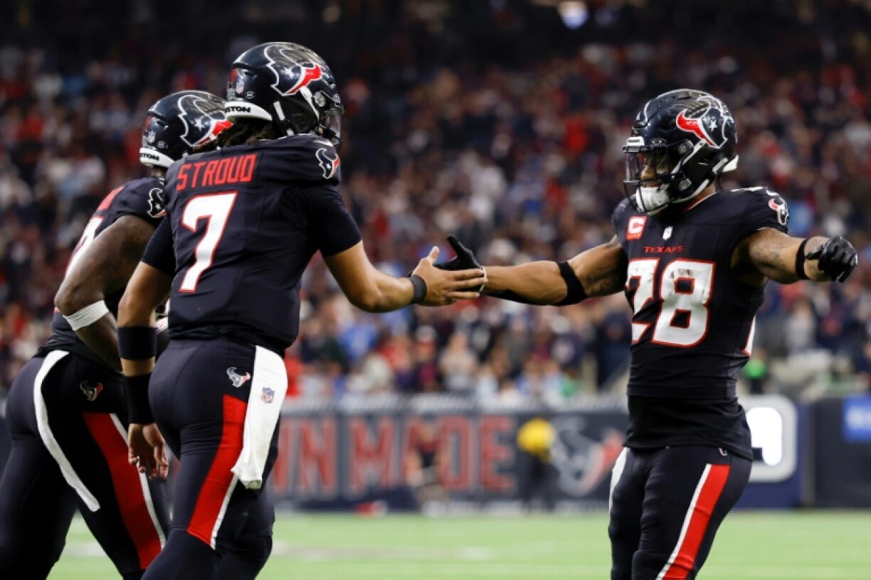 Quarterback C.J. Stroud and Joe Mixon of the Houston Texans celebrate after a touchdown in their NFL playoff victory over the Los Angeles Chargers
