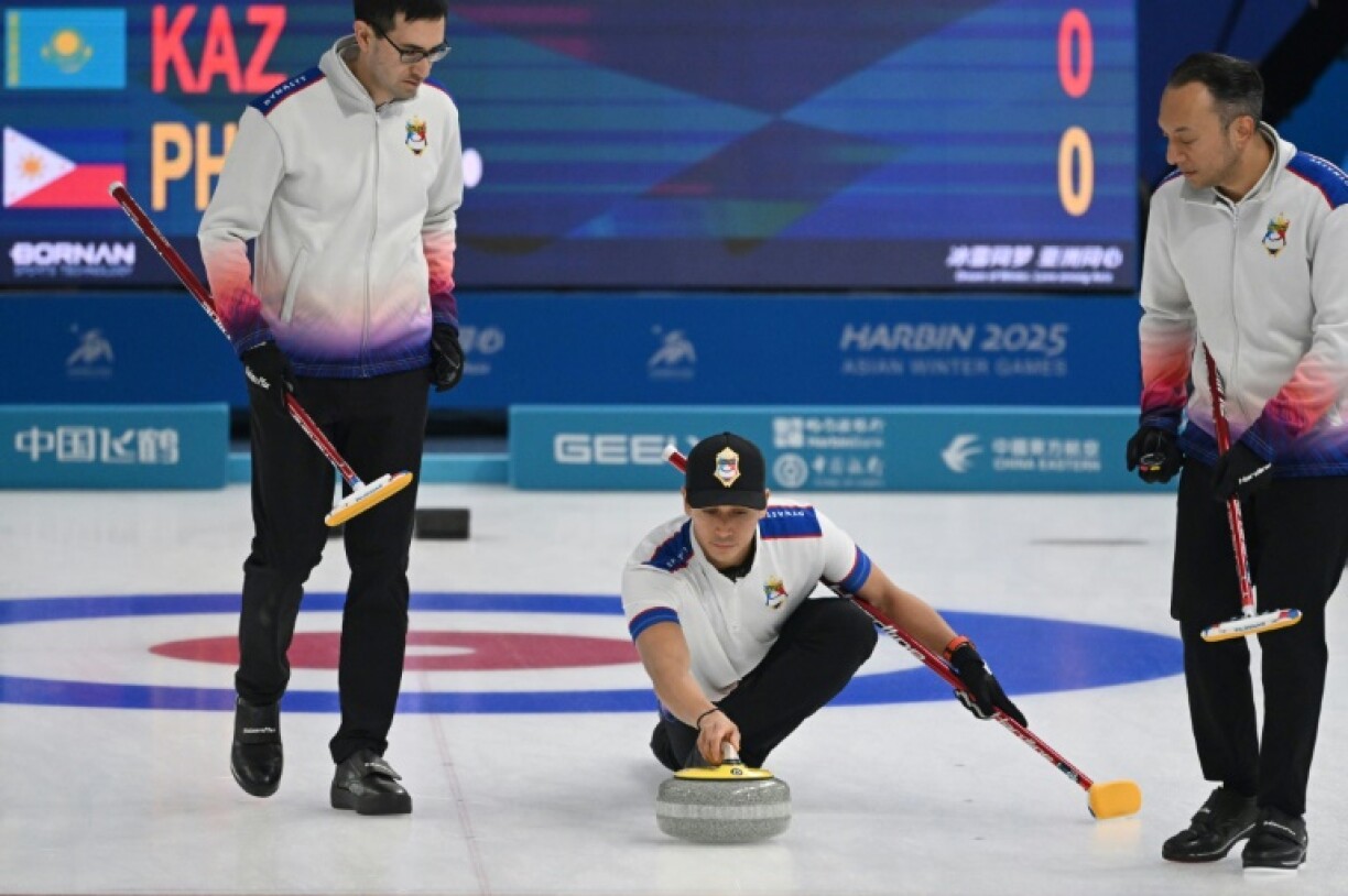 Philippines curler Enrico Pfister (centre) at the Asian Winter Games with teammate Christian Haller (left).