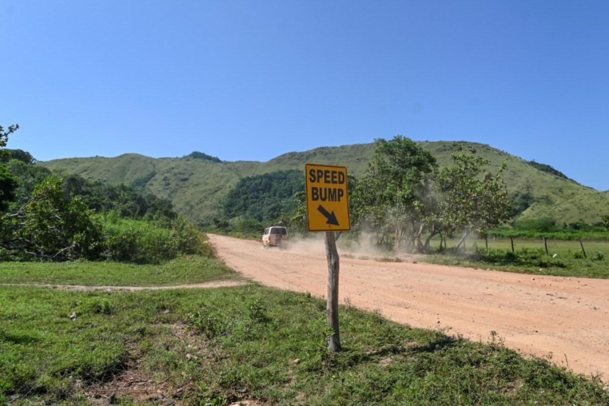 A car drives on 'The Trail' in Guyana's Essequibo region, which could greatly benefit from the road's modernization