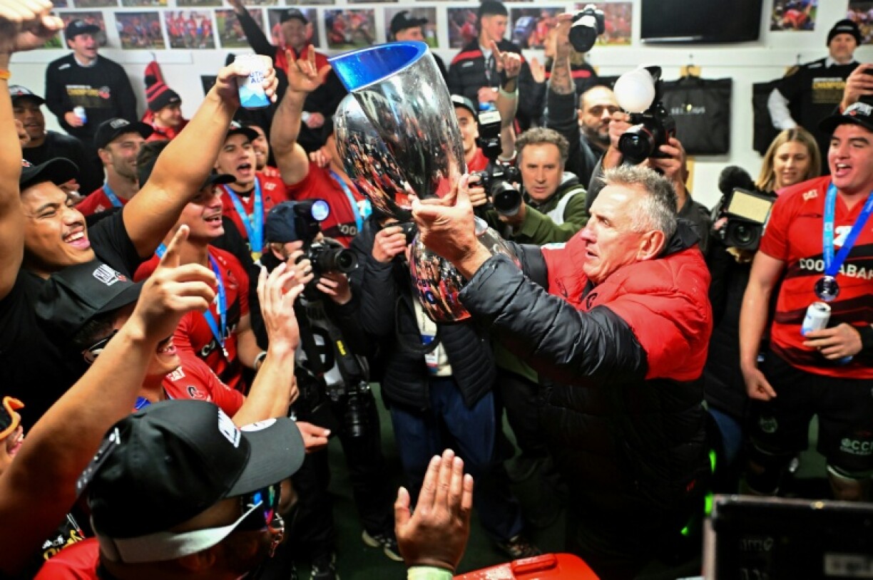 Canterbury Crusaders' head coach Rob Penney (right) and his players celebrate with the trophy in the dressing room after their victory over the Waikato Chiefs in the Super Rugby final