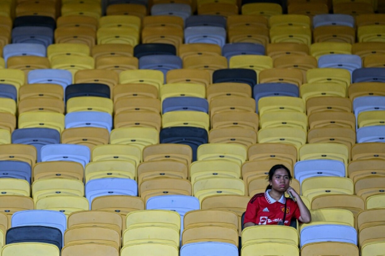 A fan sits in the stands before the friendly between Manchester United and Asean All-Stars