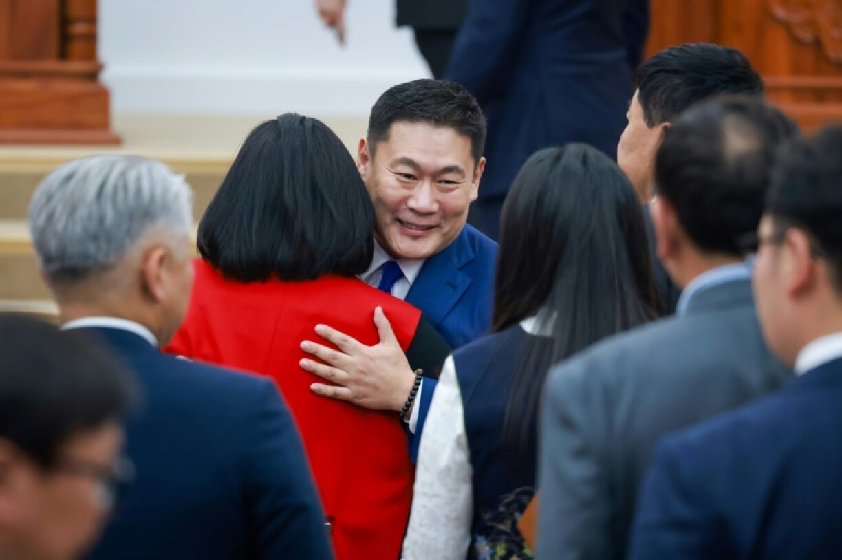 Prime Minister Luvsannamsrain Oyun-Erdene hugs members of parliament after losing a confidence vote among lawmakers
