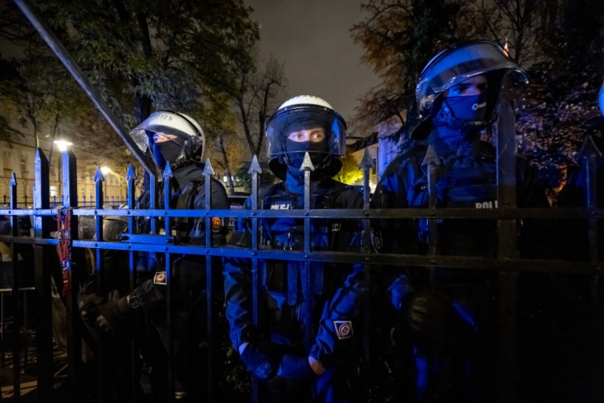 Police stand outside Poland's Constitutional Court after the apparent suspension of its chief justice