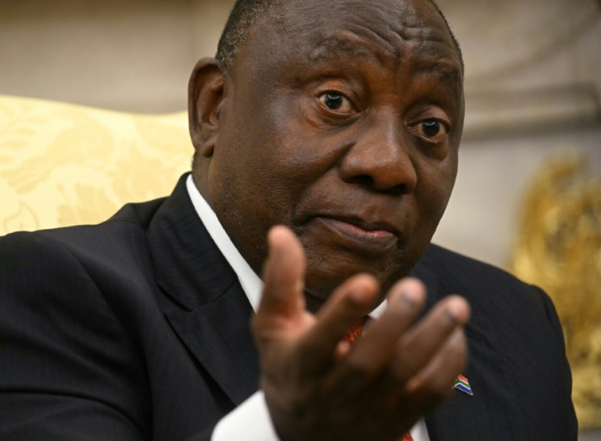 South African President Cyril Ramaphosa gestures as he speaks with US President Donald Trump in the Oval Office of the White House in Washington, DC, on May 21, 2025. South African President Cyril Ramaphosa meets Donald Trump on Wednesday amid tensions over Washington's resettlement of white Afrikaners that the US president claims are the victims of