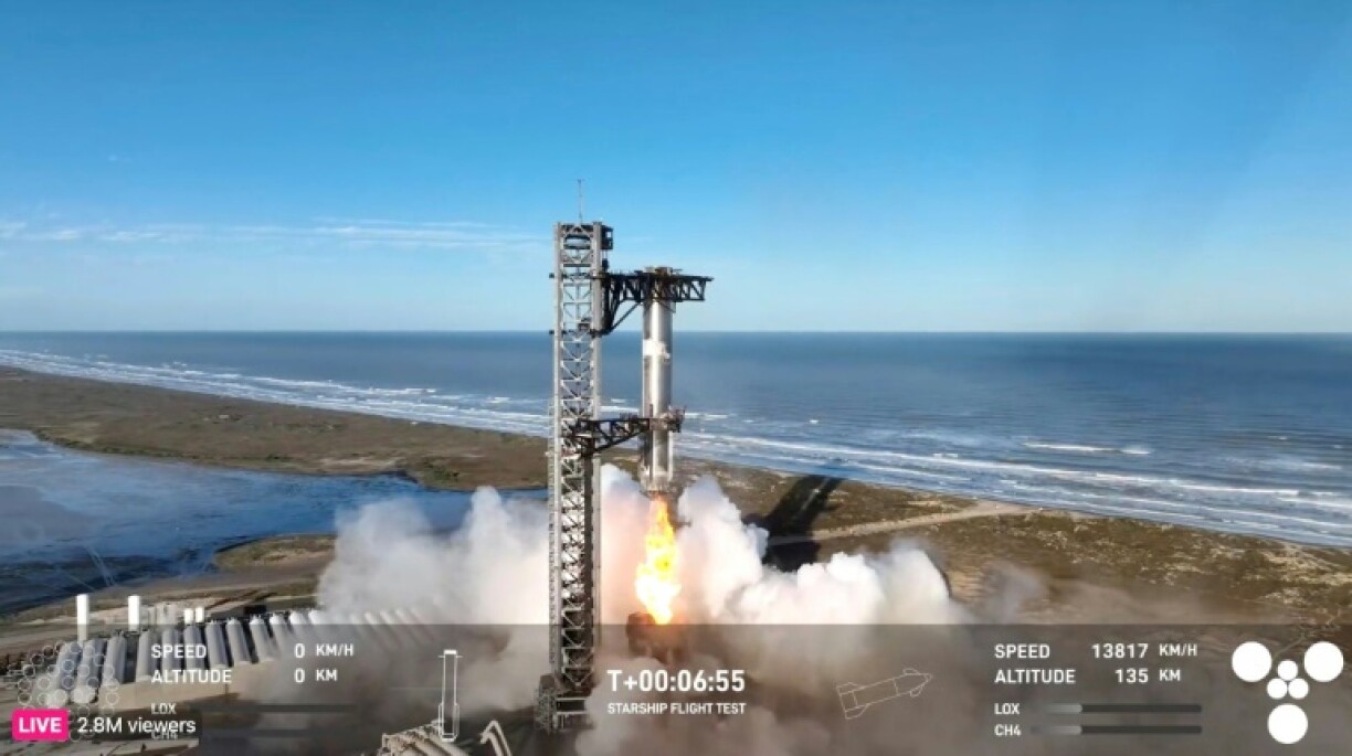In this screen grab taken from the SpaceX broadcast the Starship's Super Heavy Booster is being grappled mid-air as it returns to the launch pad at Starbase near Boca Chica, Texas, on January 16, 2025