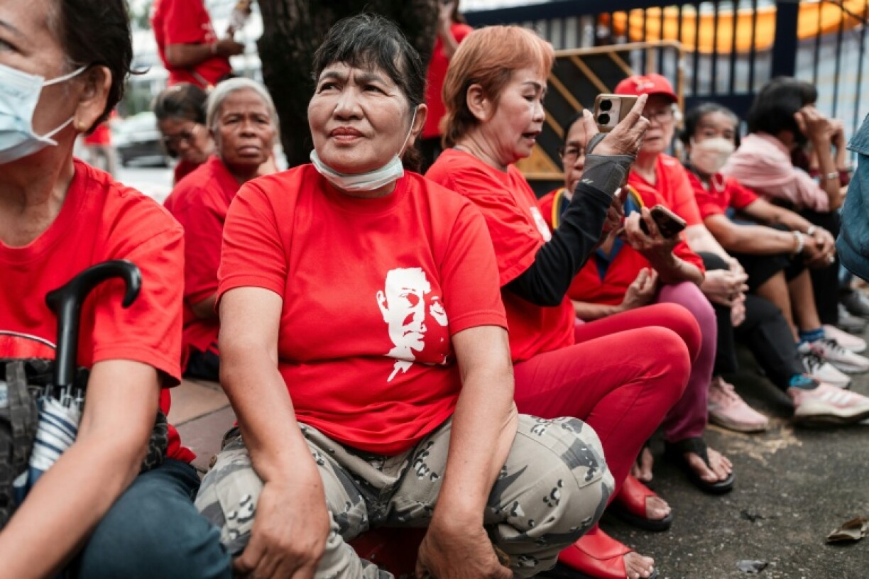 Around 50 Thaksin supporters were gathered at the courthouse wearing shirts the red colour of his political movement and emblazoned with a portrait of his face