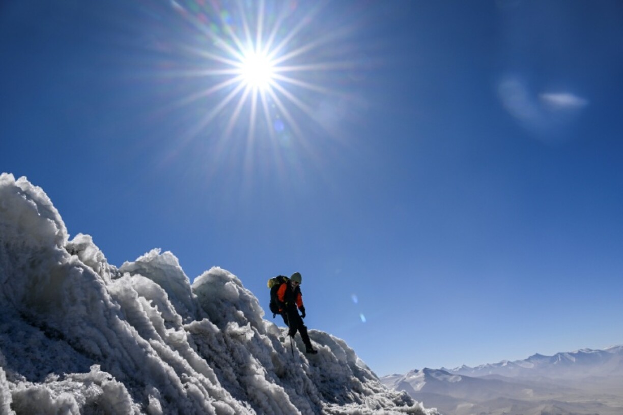 Swiss glaciologist Andreas Henz treks up the mountain