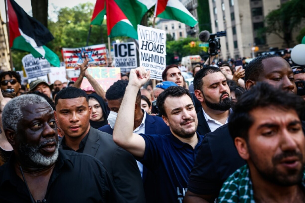 Pro-Palestinian protest leader Mahmoud Khalil raises his fist as he marches to Columbia University in New York City just two days after his release from US detention