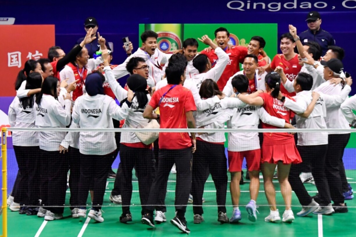 Members of Indonesia's team celebrate after winning the Badminton Asia Mixed Team Championships in Qingdao