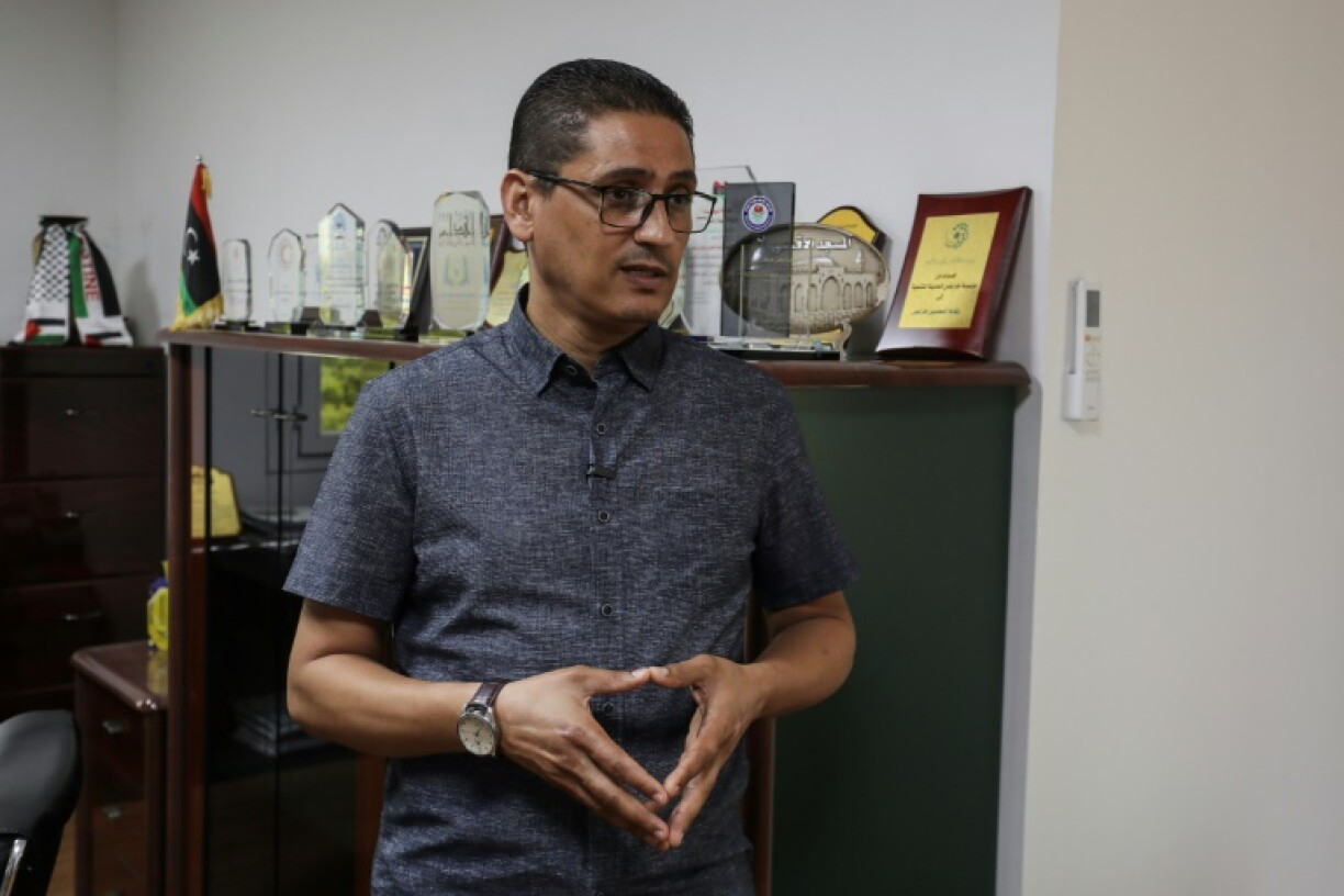 Ashraf Abu Rawi, spokesperson for Libya's teachers' union, speaks with an AFP journalist at his office in Tripoli on September 27, 2026, during a teachers' strike demanding higher salaries and better working conditions.