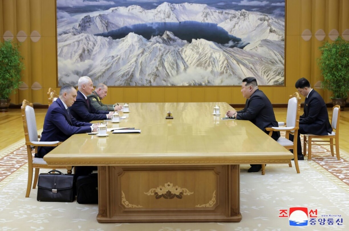 Russian Defence Minister Andrei Belousov (L) and North Korea's Kim Jong Un meet on Friday in Pyongyang