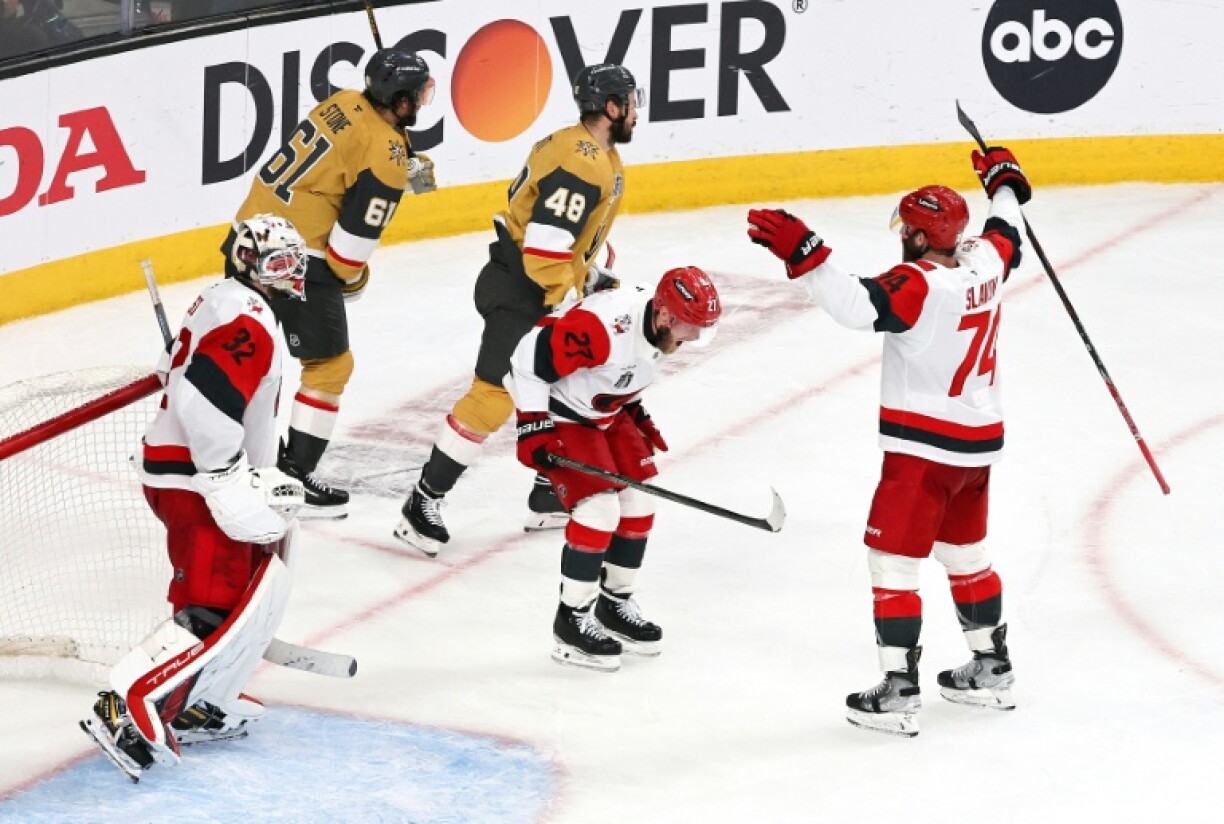 Carolina's Brandon Bussi, left, Nikolaj Ehlers, center, and Jaccob Slavin celebrate during the Stanley Cup Final, which the Hurricanes won to set up a championship banner raising at the 2026-27 NHL season opener against Florida at Raleigh, North Carolina