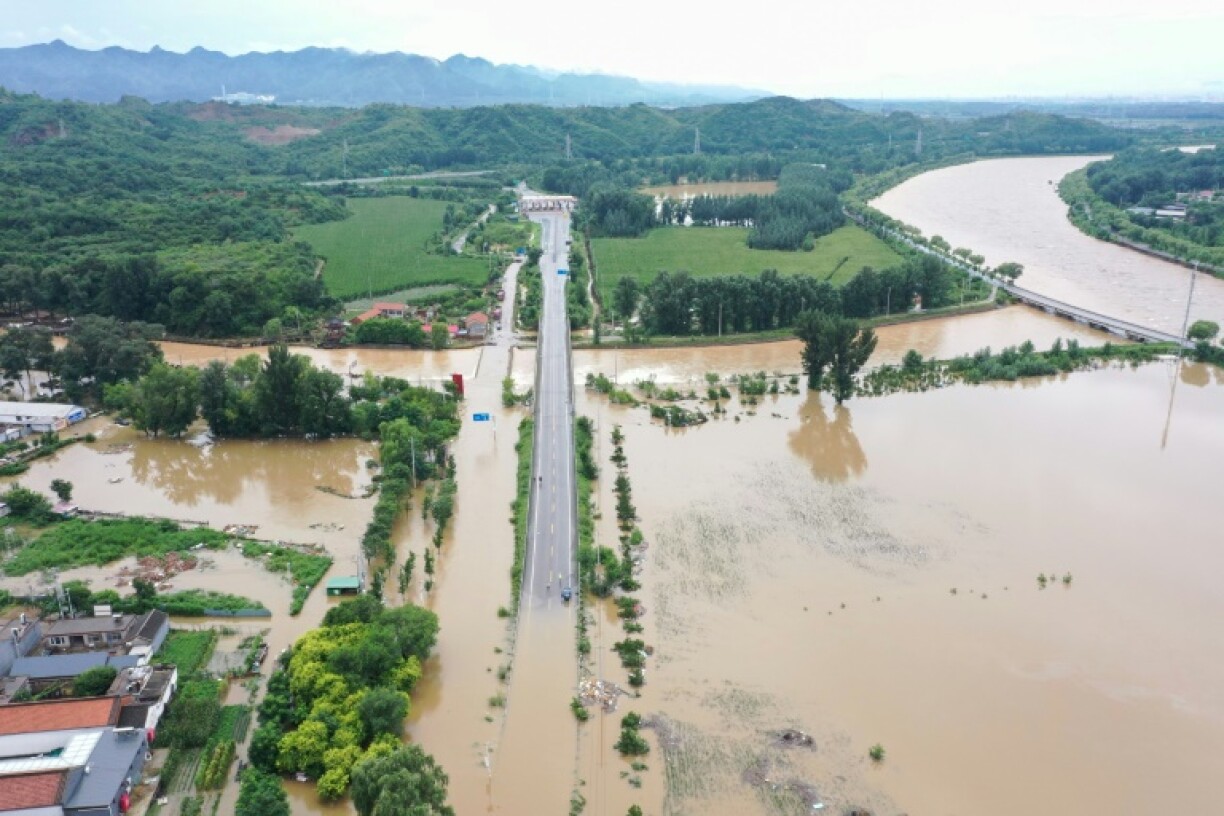 Spillways gush with torrents of water leading out of the Miyun Reservoir, which authorities said has reached its highest levels since its construction in 1959