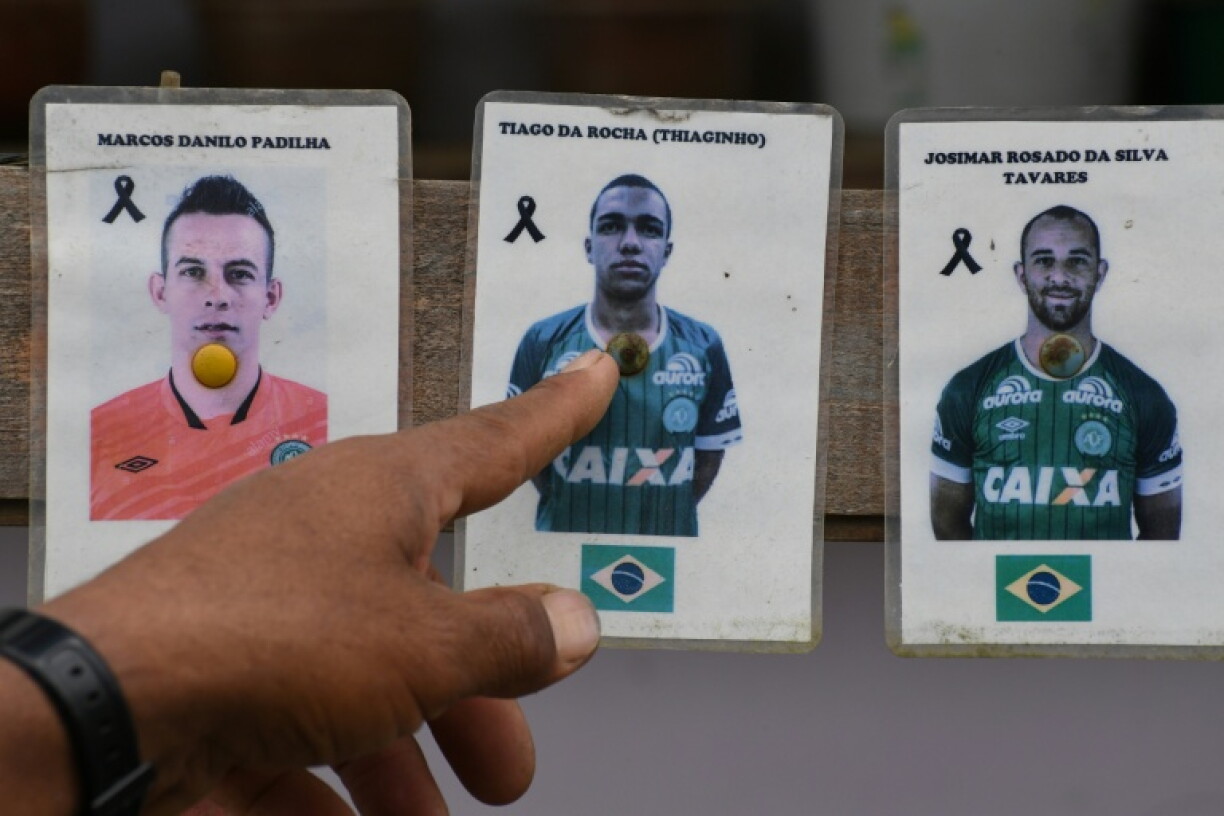 A Colombian who helped rescue survivors from the plane crash that wiped out the Brazilian football team Chapecoense in 2016 points to pictures of the victims