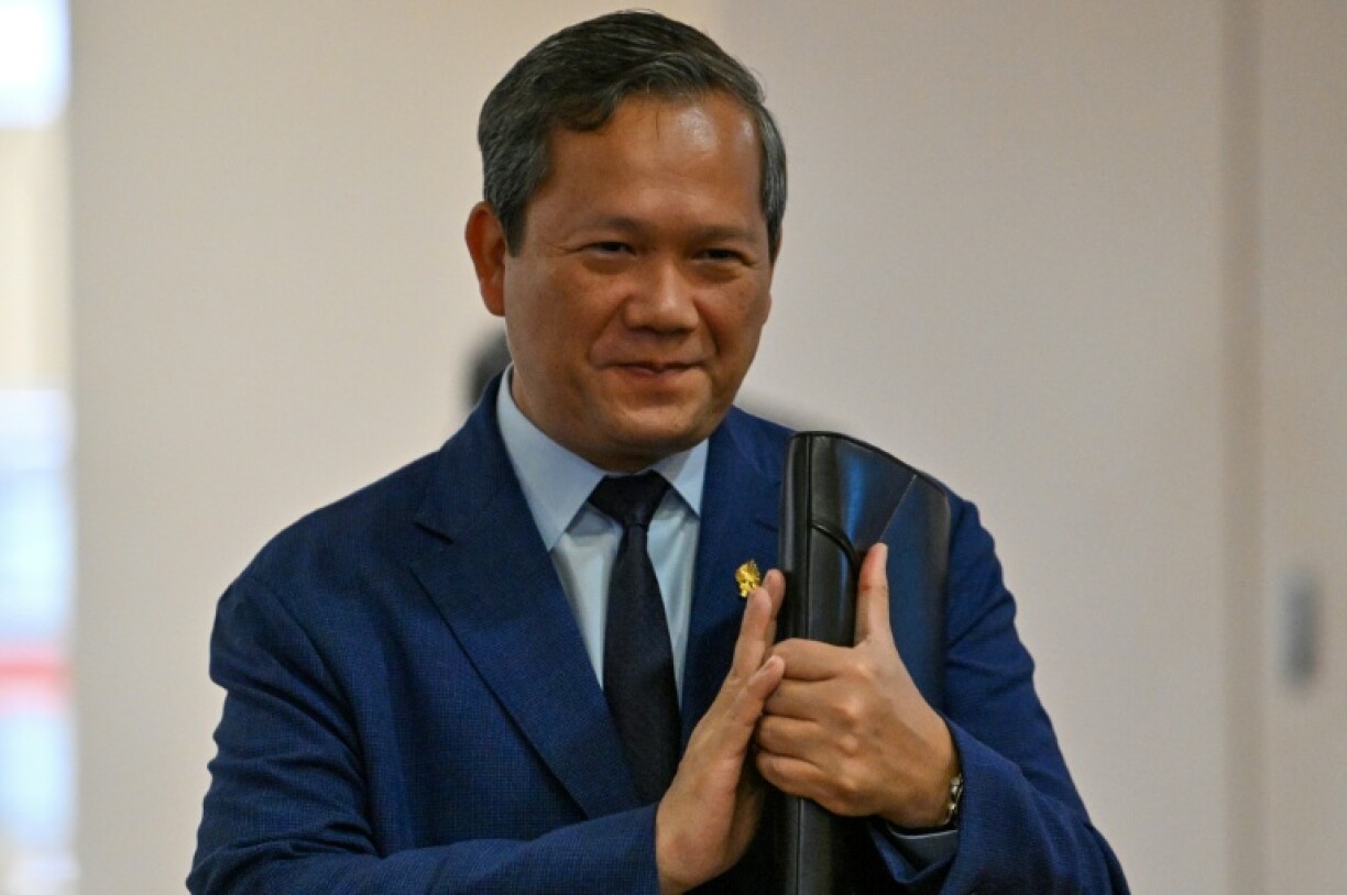 Cambodian Prime Minister Hun Manet greets people as he arrives at the National Assembly on Monday