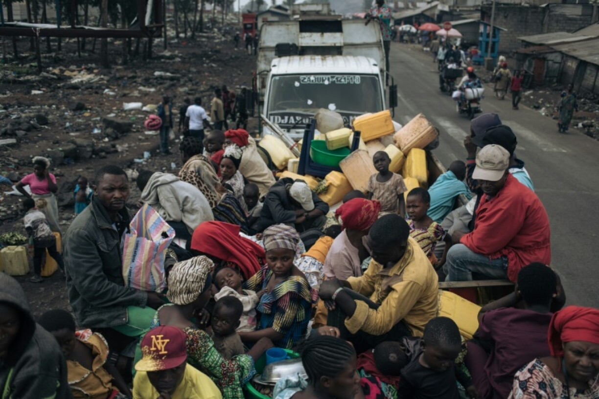 War-displaced people board trucks to leave camps in Goma