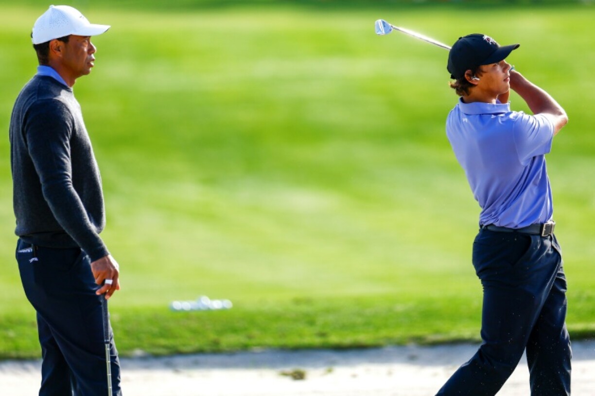 Tiger Woods, left, watches son Charlie practice ahead of the weekend's 36-hole PNC Championship for parent and child pairs