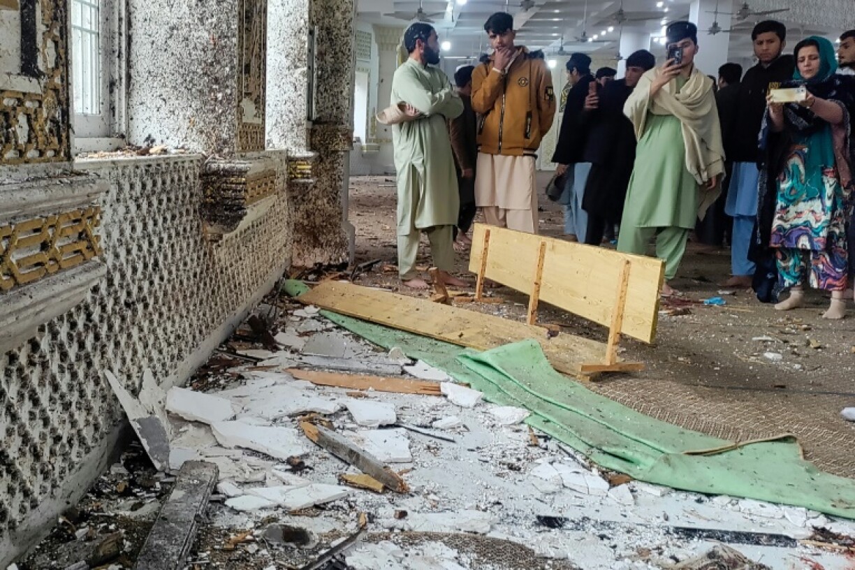 Onlookers gather after a suicide blast during Friday prayers at Dar-ul-Uloom Haqqania school in Akora Khattak, east of Peshawar Friday