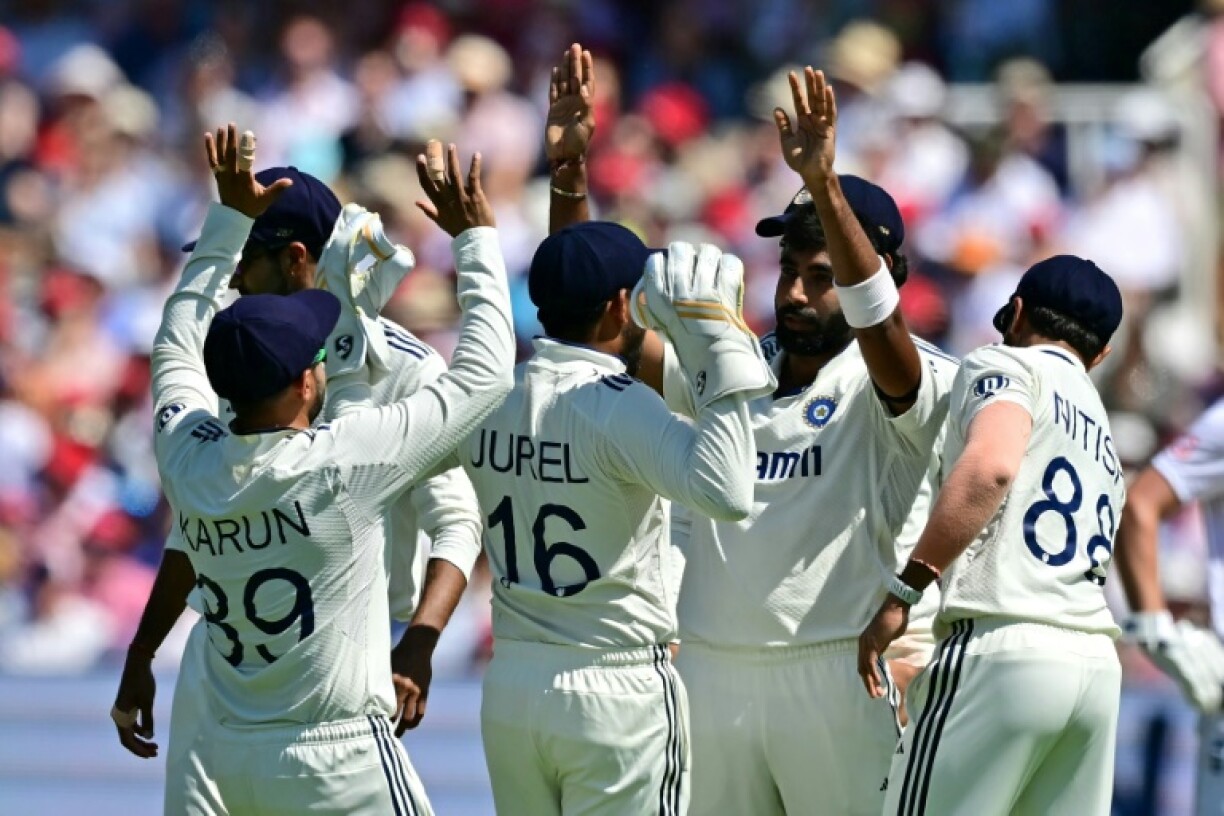 India's Jasprit Bumrah (2R) celebrates with team-mates after bowling England's Joe Root for 104 in the third Test at Lord's