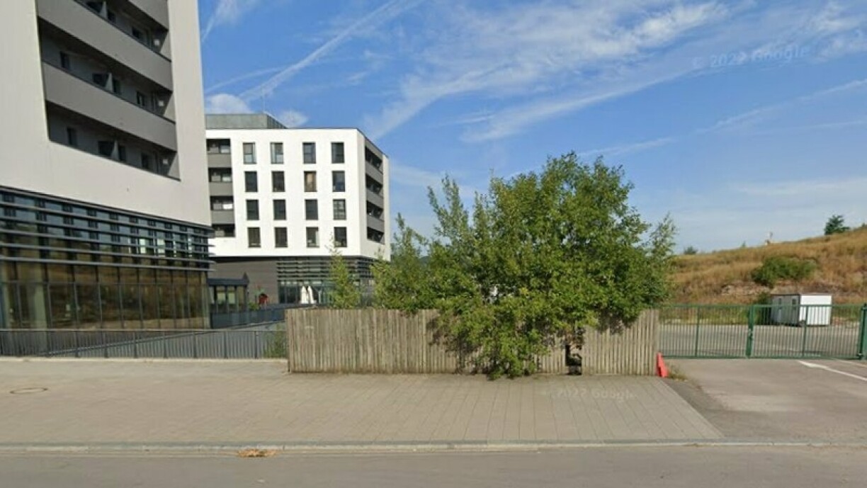 Picture of the nursery at the entry of Belval, with the building in question in the background.