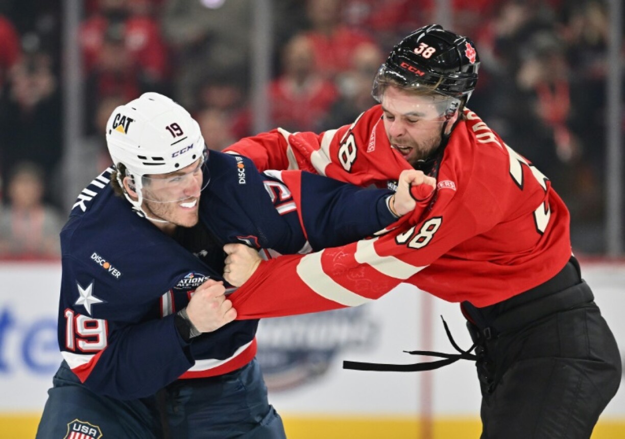 Team USA's Matthew Tkachuk, left, fights Brandon Hagel, right, of Team Canada at the start of an intense 4 Nations Face-Off game in Montreal