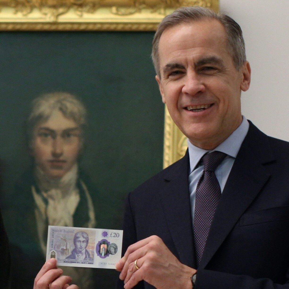 Mark Carney, then the governor of the Bank of England, displays the new 20-pound note in February 2020