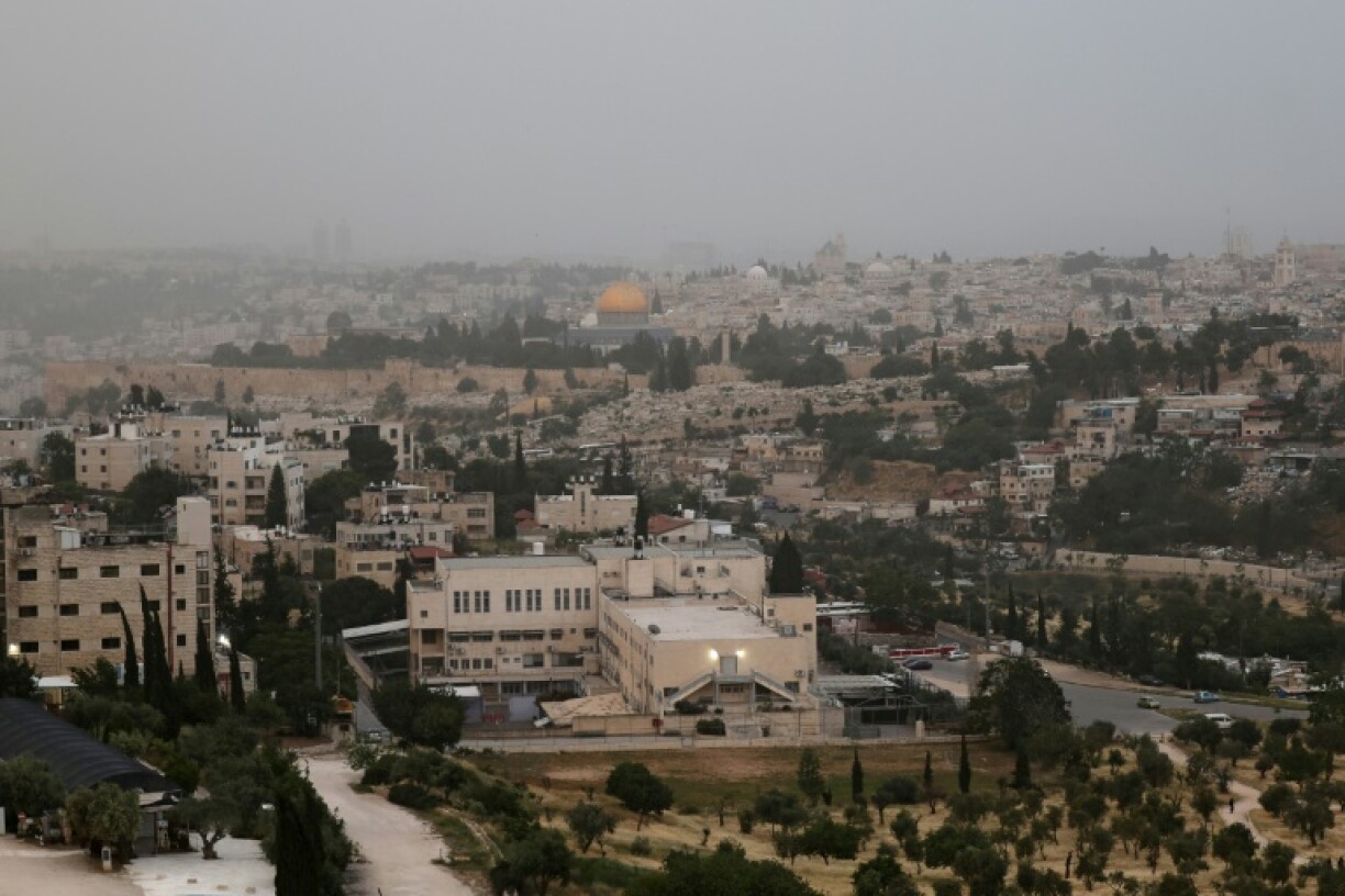 Jerusalem seen as a cloud of smoke rises from a large forest fire on the outskirts of the city