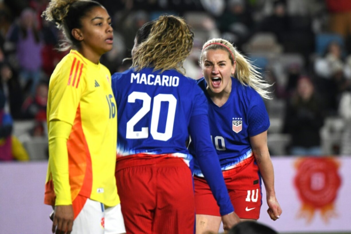 Catarina Macario celebrates with teammate Lindsey Heaps after opening the scoring against Colombia