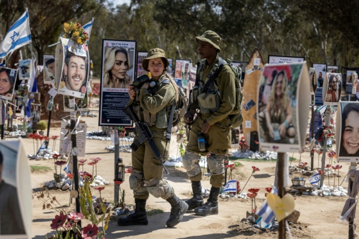 Israeli soldiers patrol at a memorial for the victims at the site of the Nova music festival attack that took place on October 7, 2023