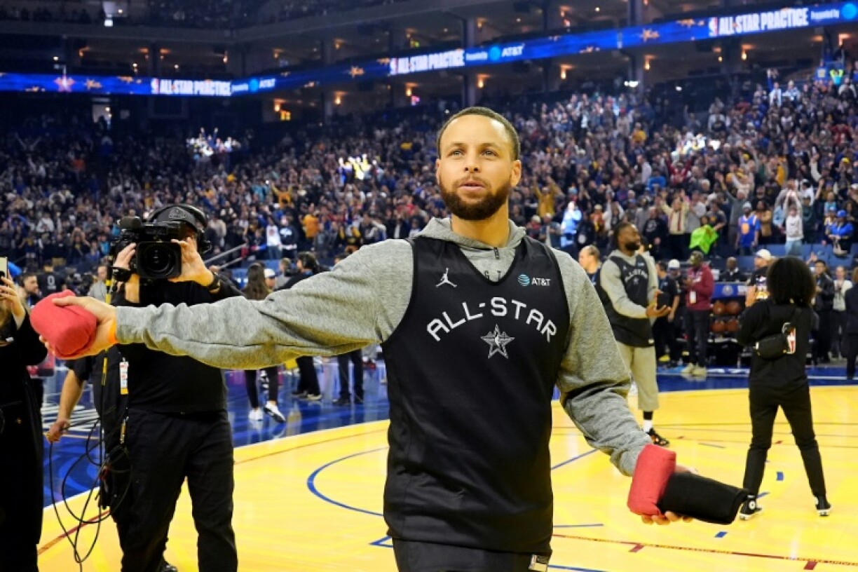 Stephen Curry of the Golden State Warriors throws shirts to fans during NBA All-Star practice