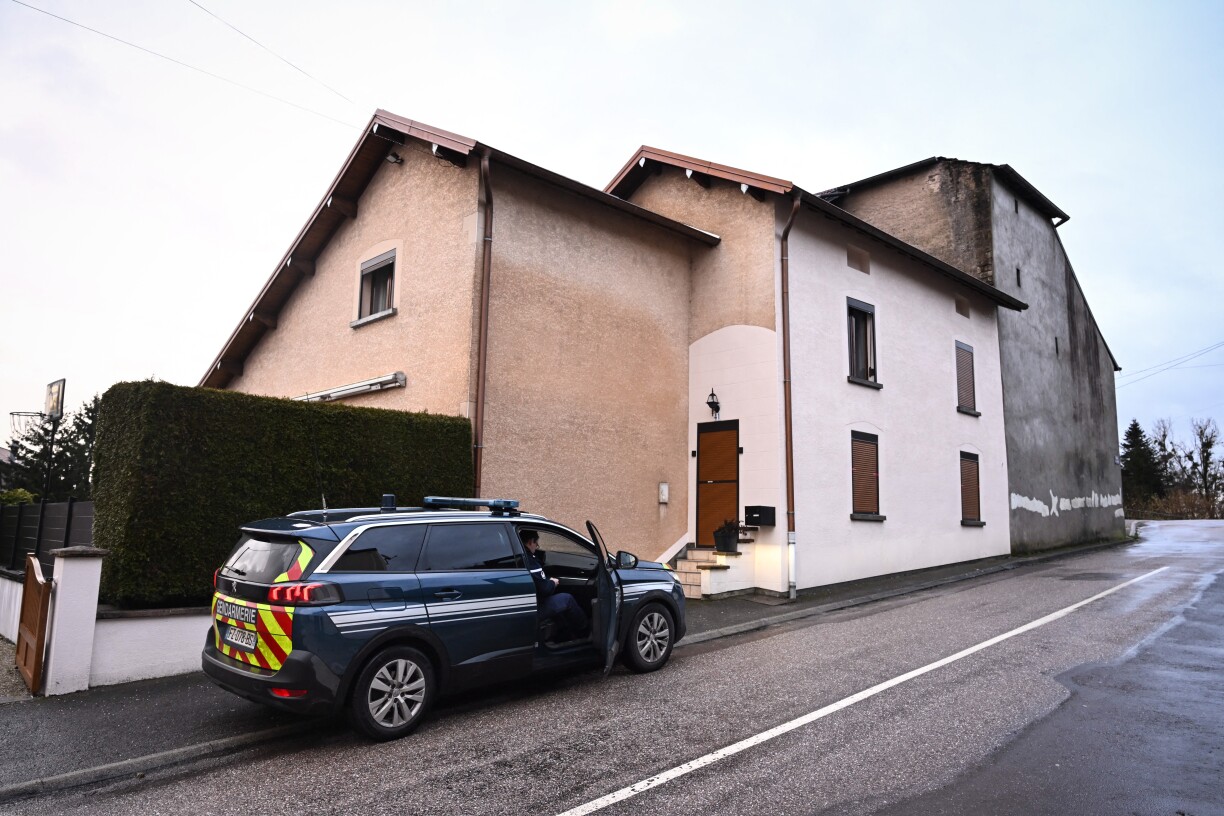 French Gendarmes gather outside the house where the bodies of two infants have been discovered in a freezer in Ailleviller-et-Lyaumont, eastern France on 12 February 2026.