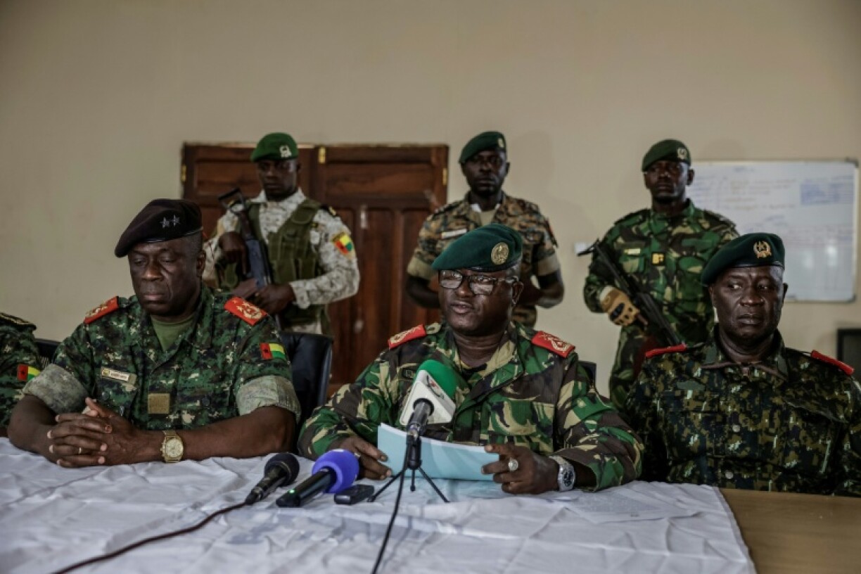 Brigadier General Denis N'Canha (C), head of the military office of the presidency, gave a press conference announcing the takeover