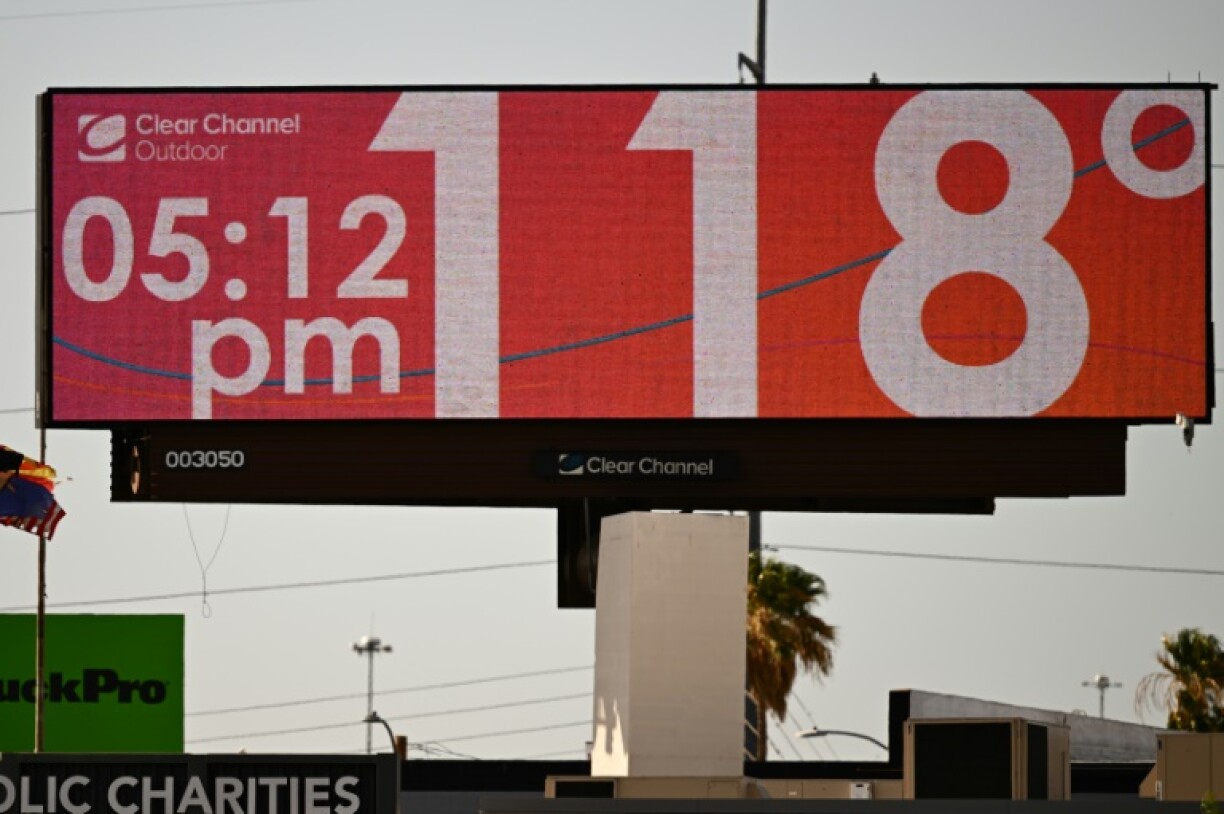 A billboard displays a temperature of 118 degrees Fahrenheit (48 degrees Celsius) during a record heat wave in Phoenix, Arizona on July 18, 2023
