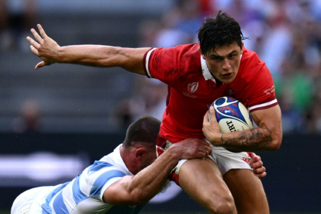 Wales' wing Louis Rees-Zammit (R) is tackled by Argentina's Marcos Kremer in a 2023 Rugby World Cup quarter-final