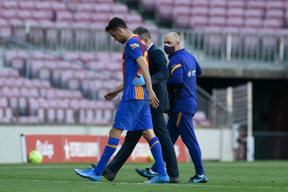 Le milieu de terrain de Barcelone, Sergio Busquets, quitte la pelouse après s'être blessé contre l'Atlético Madrid, lors de leur match de Bundesliga, le 8 mai 2021 au Camp Nou