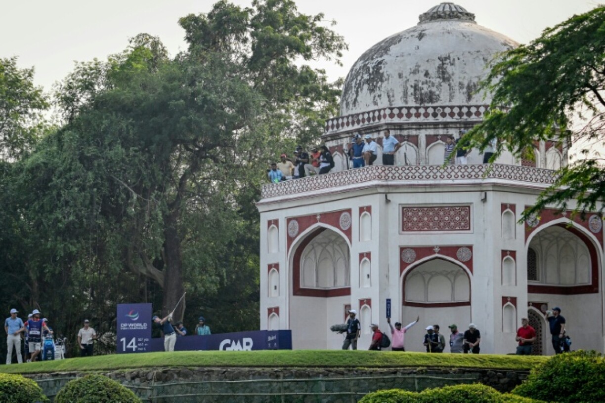 Rory McIlroy tees off beside a Mughal-era heritage monument during the DP World India Championship at the Delhi Golf Club