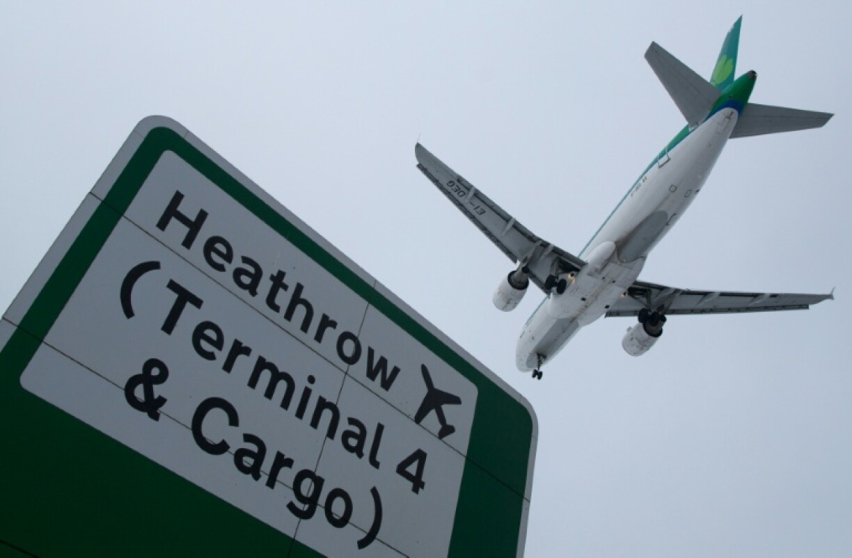A plane flies in to land at Heathrow airport