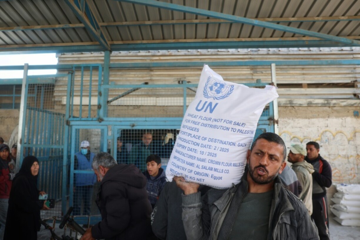 A man receives food aid from a UN distribution centre in central Gaza after Israel announced a block on aid flows into the territory