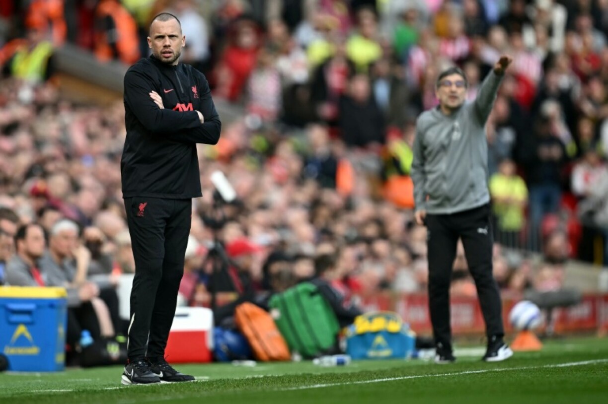 John Heitinga (L) had been working under Arne Slot at Liverpool