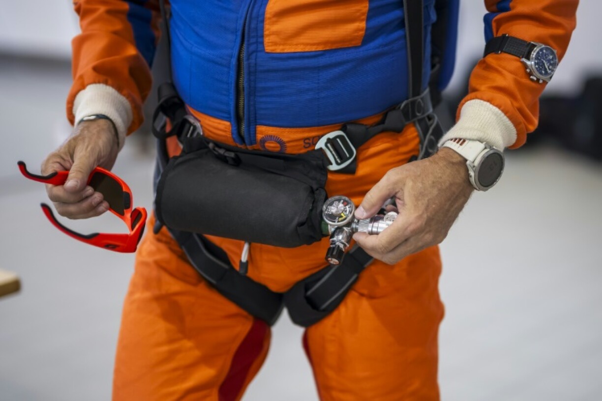 Raphael Domjan holds his oxygen cylinder as the Swiss adventurer prepares to get into the SolarStratos plane