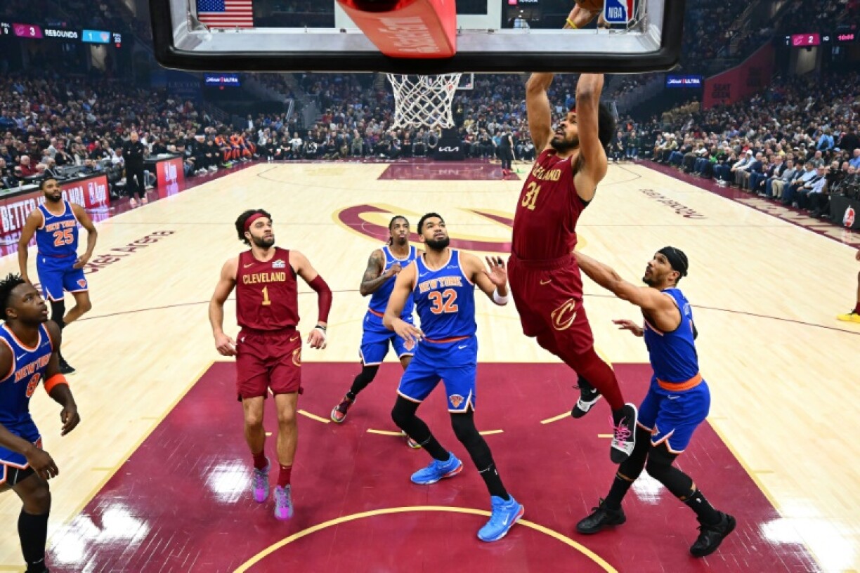 Jarrett Allen of the Cleveland Cavaliers dunks over Karl-Anthony Towns in the Cavaliers' NBA victory over the New York Knicks