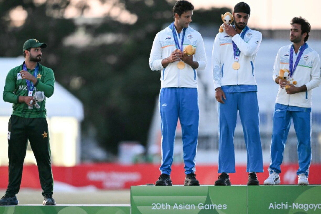 Gold medallists India (R) and silver medallists Pakistan (L) stand on the podium