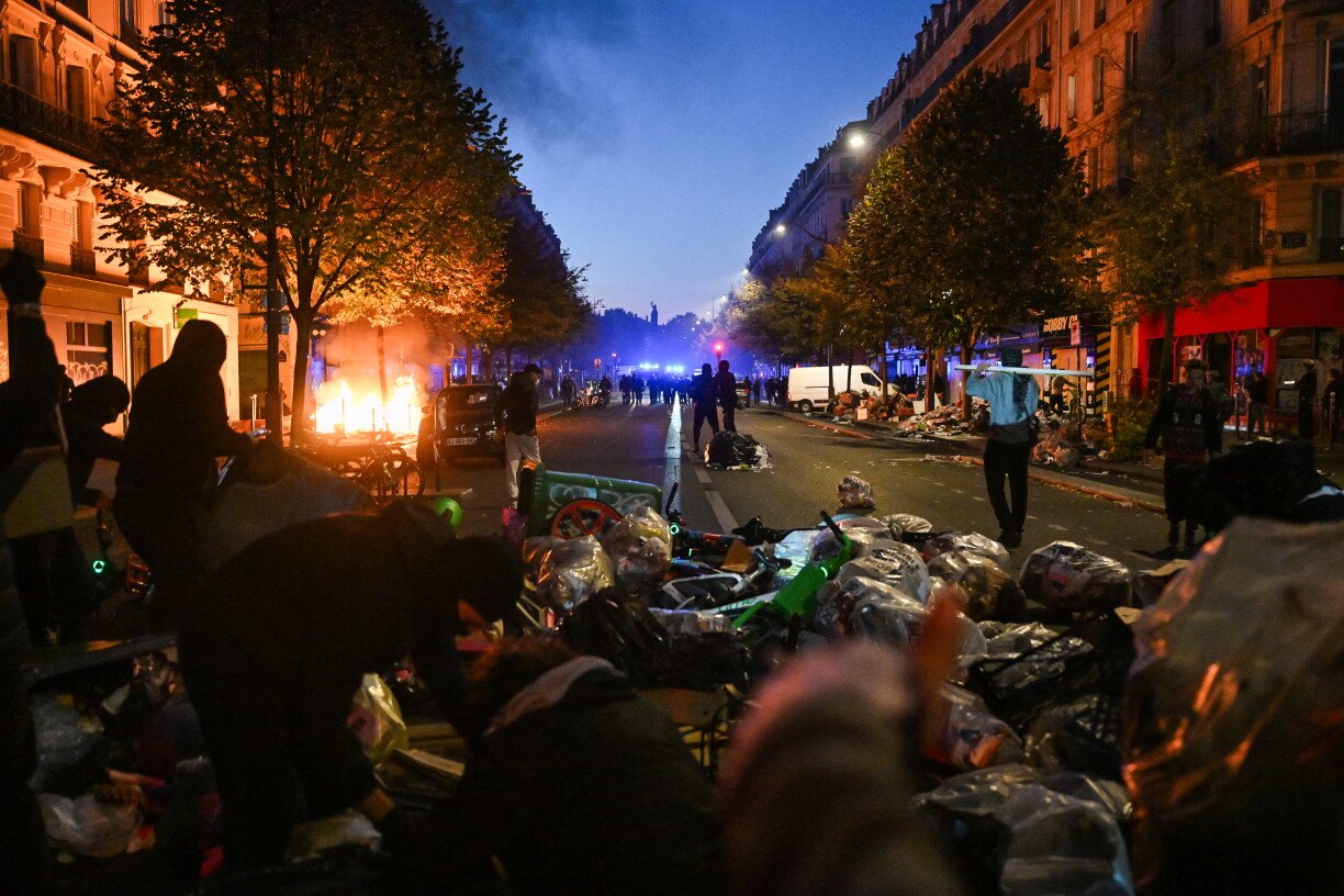 TOPSHOT - Protestors put objects such as trashes or bike on the Boulevard Voltaire as clashes erupted at Place de la Republique following an unauthorised demonstration, central Paris, on October 18, 2026 a day after nationwide protests against the "high cost of living".