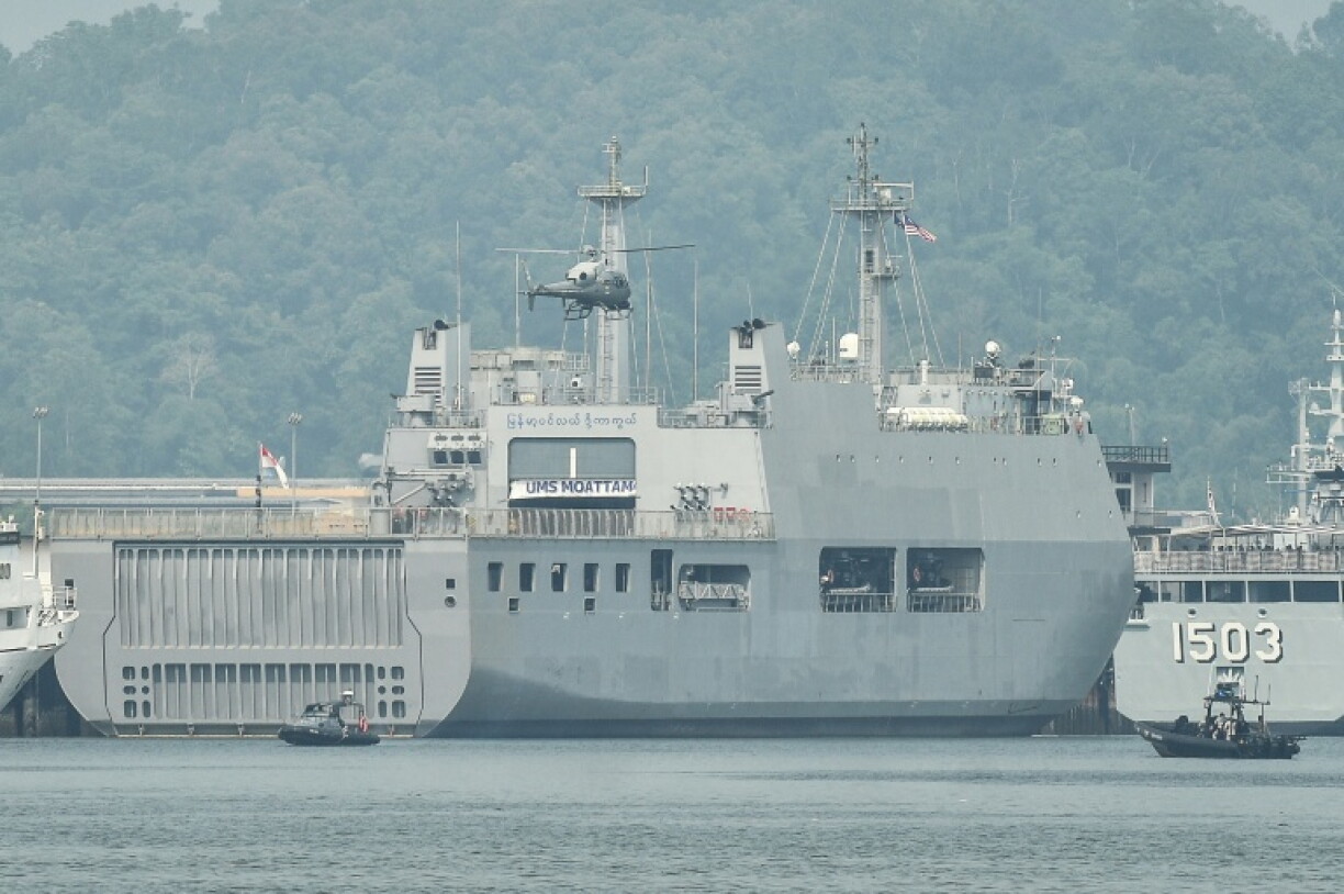 A Malaysian Navy helicopter patrols an area near ships waiting to transport dozens of Myanmar nationals at Lumut, on the outskirts of Kuala Lumpur
