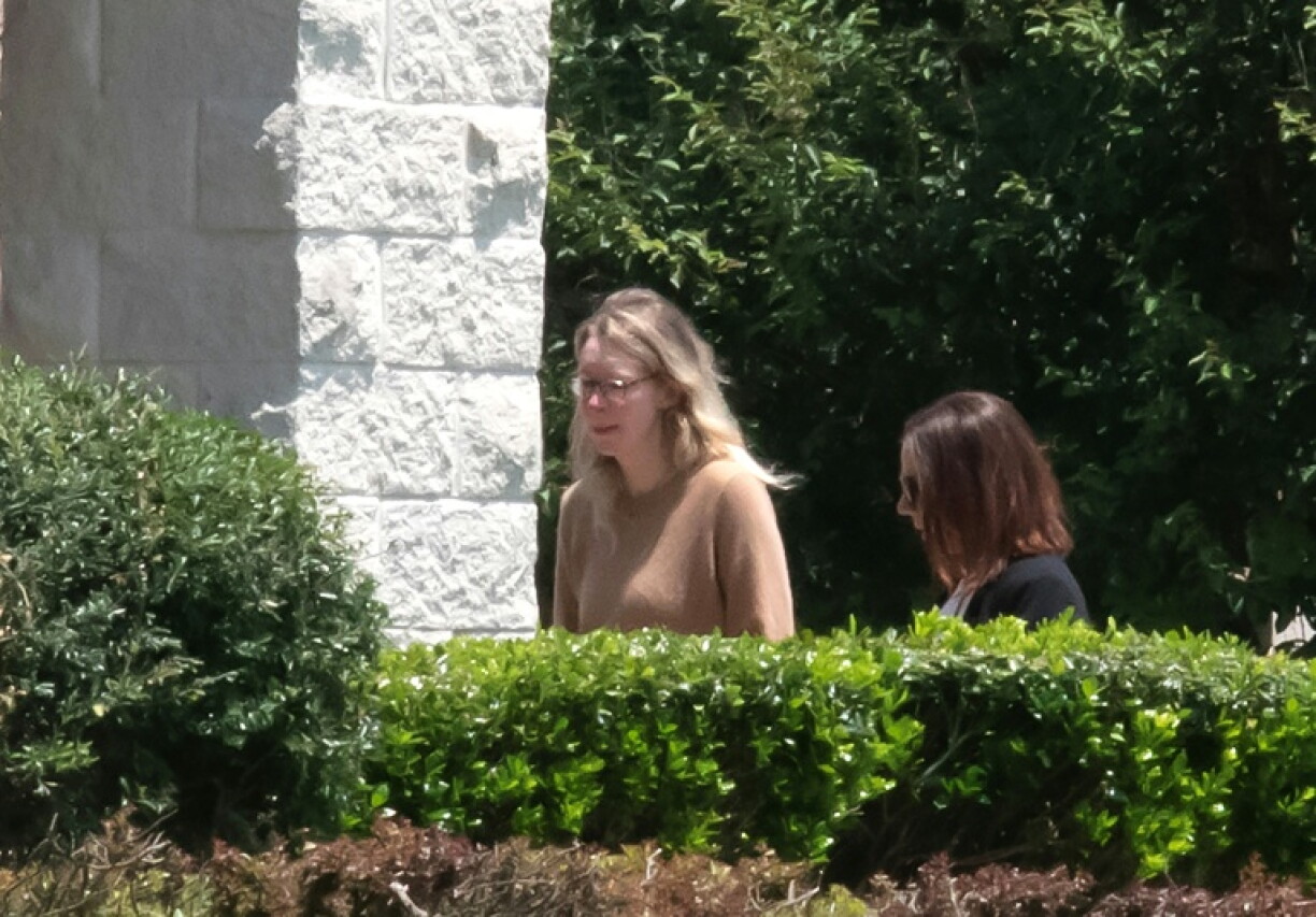 Theranos founder Elizabeth Holmes (L) arrives at a federal prison in Bryan, Texas, on May 30, 2023